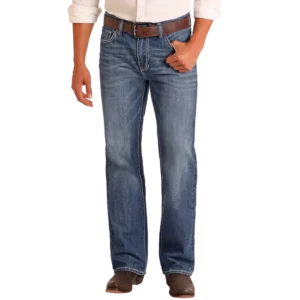 Man wearing the Double Barrel relaxed straight leg jeans in a medium vintage wash, representing classic western wear.