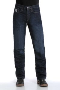 Man wearing the Cinch Silver Label rigid denim jeans, showcasing the modern low rise and versatile slim fit.