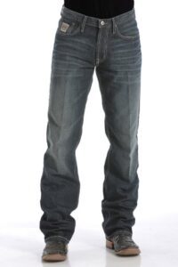 Man wearing the iconic Cinch White Label relaxed fit jeans in a dark stonewash, showcasing authentic western wear.